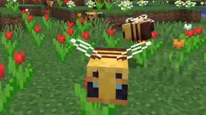 This is a screenshot of a minecraft game where there are three bees in the frame. All of them are hovering around red and orange tulips.
